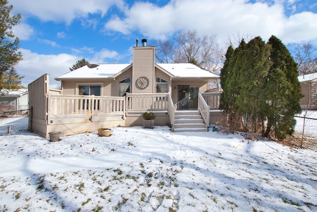 snow covered house with covered porch