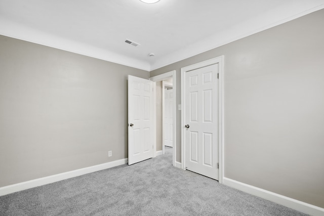 unfurnished bedroom featuring light carpet