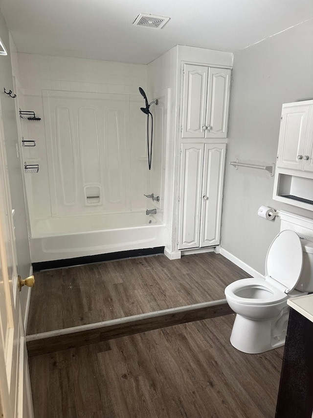 full bathroom with vanity, hardwood / wood-style floors, bathing tub / shower combination, and toilet