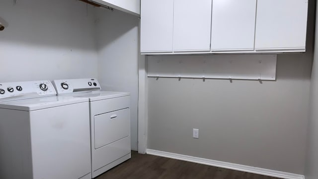 clothes washing area featuring cabinets, dark hardwood / wood-style floors, and washing machine and dryer