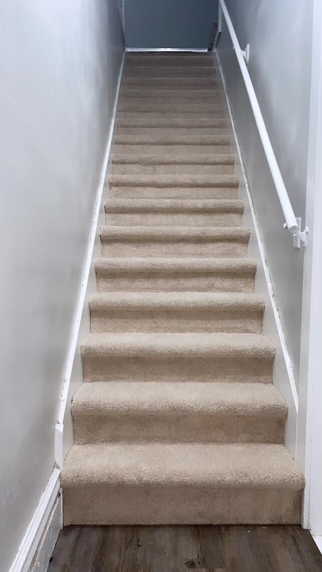 staircase with hardwood / wood-style flooring