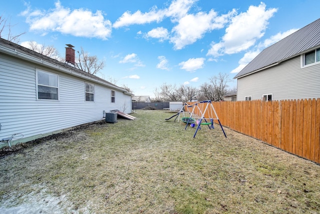 view of yard with cooling unit and a playground