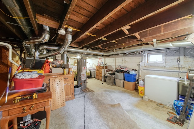 basement with water heater and fridge