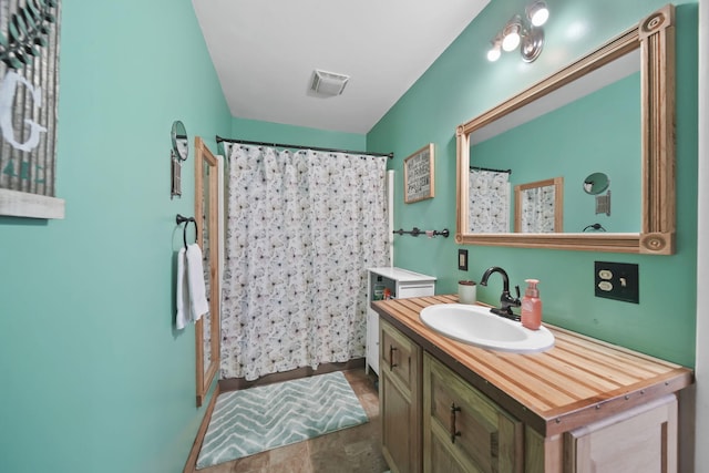 bathroom with vanity and walk in shower