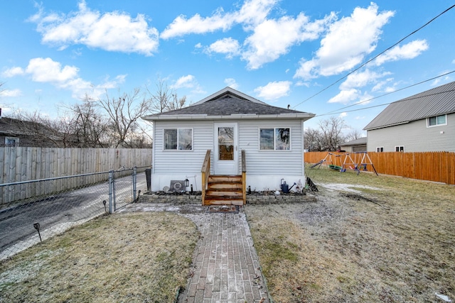 bungalow with a front lawn and a playground