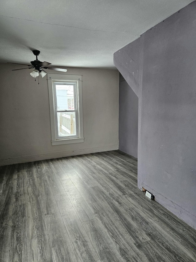 445 Colfax St, Cadillac, MI 49601 - additional living space featuring wood finished floors, a ceiling fan, and a textured ceiling
