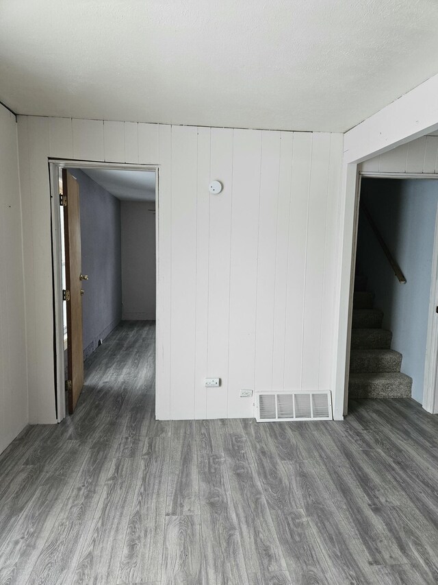 445 Colfax St, Cadillac, MI 49601 - unfurnished room featuring wood finished floors and stairway