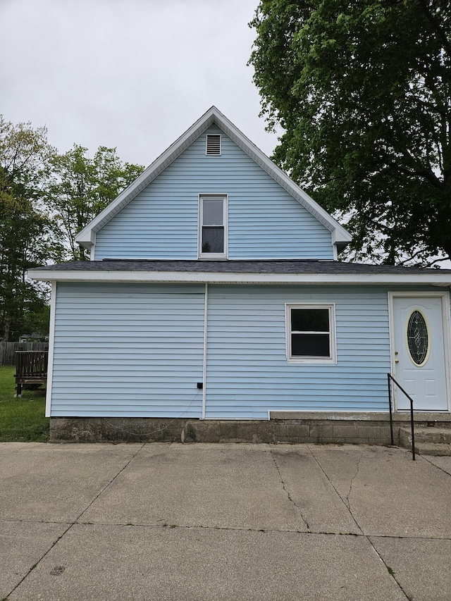 445 Colfax St, Cadillac, MI 49601 - view of side of property with a garage and entry steps