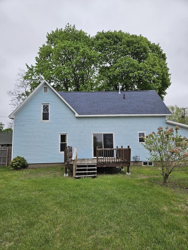 445 Colfax St, Cadillac, MI 49601 - back of house featuring a deck, a yard, and a shingled roof