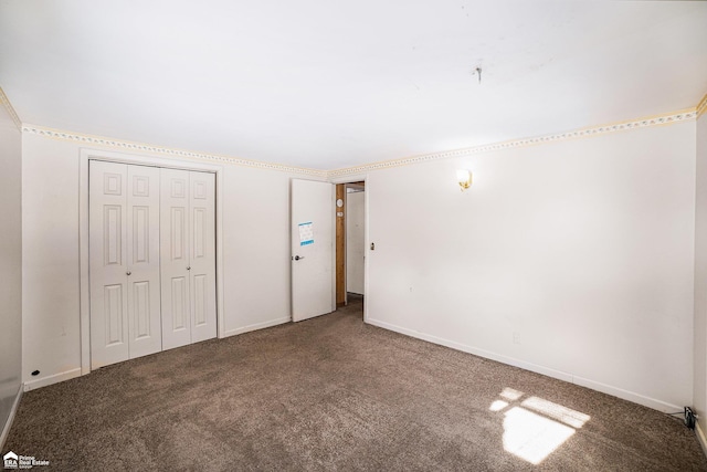 unfurnished bedroom with carpet floors and a closet