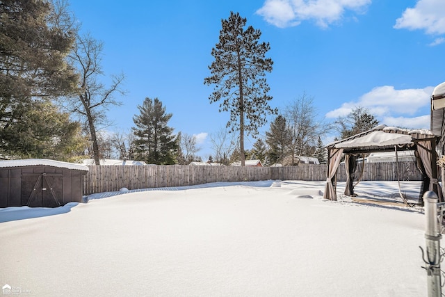 yard covered in snow with a gazebo