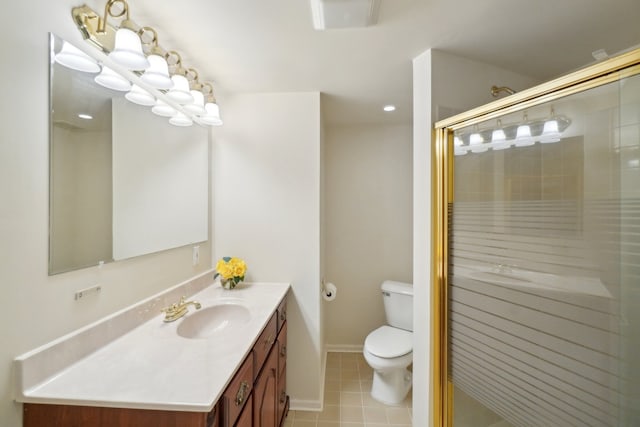 bathroom featuring toilet, vanity, baseboards, tile patterned floors, and a stall shower