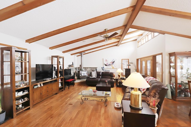 living area with ceiling fan, wood finished floors, beamed ceiling, french doors, and high vaulted ceiling