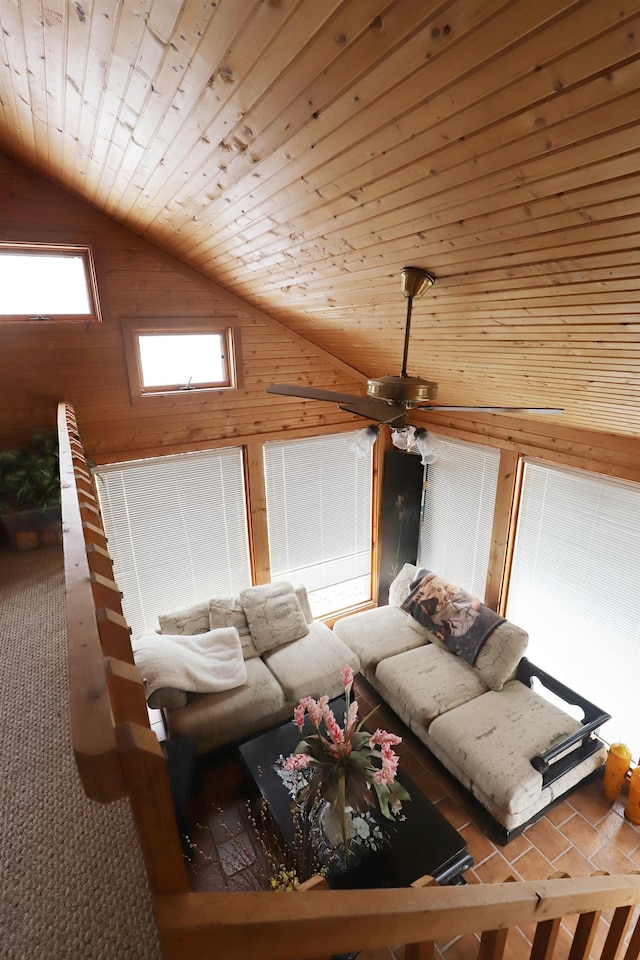 unfurnished living room with wooden ceiling, carpet, wooden walls, and vaulted ceiling