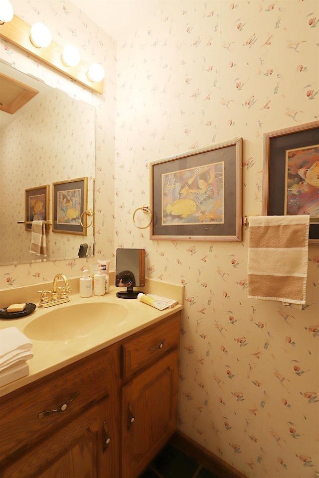 bathroom featuring wallpapered walls and vanity