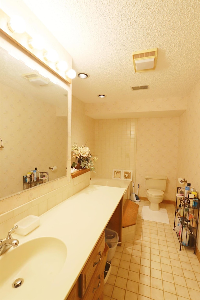 bathroom featuring wallpapered walls, visible vents, tile patterned floors, a textured ceiling, and vanity