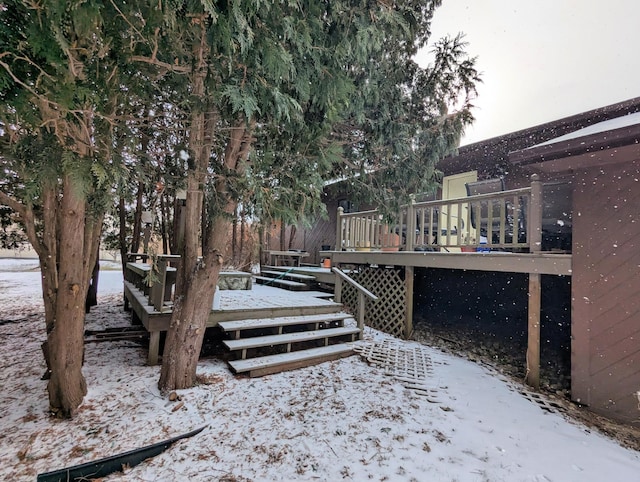 yard covered in snow with a wooden deck