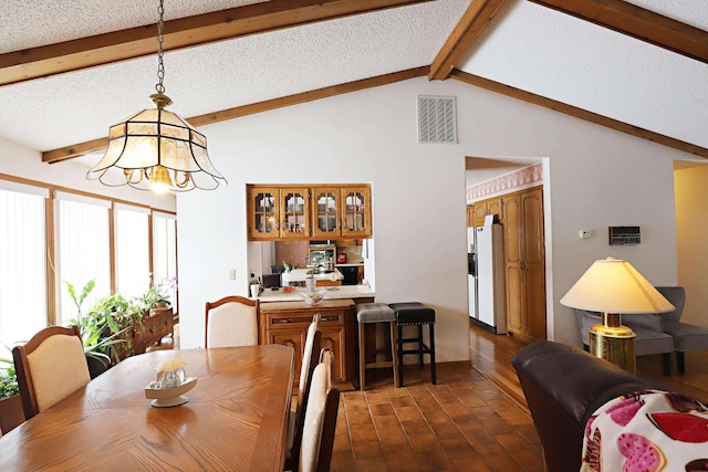 dining space featuring a textured ceiling, lofted ceiling with beams, dark wood-type flooring, visible vents, and an inviting chandelier