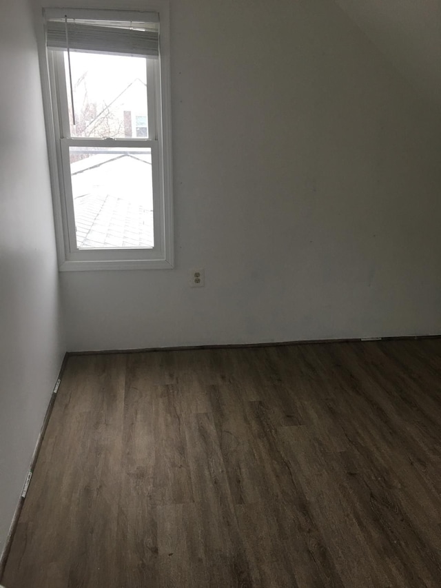 unfurnished room featuring dark hardwood / wood-style flooring