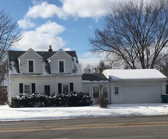 new england style home with a garage