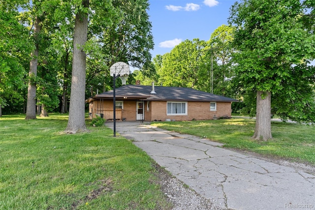 1408 Stephens Ave, Flint, MI 48507 - ranch-style home with brick siding, a front lawn, and driveway