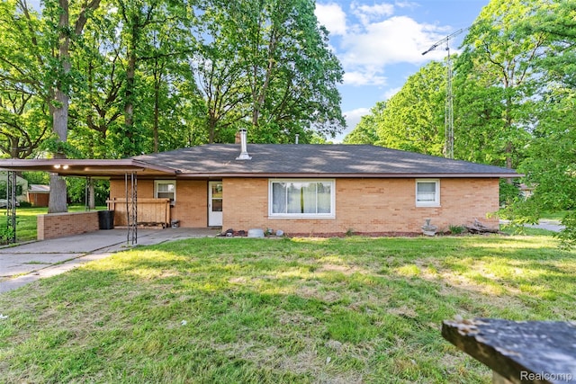 1408 Stephens Ave, Flint, MI 48507 - ranch-style home with brick siding, a carport, and a front yard