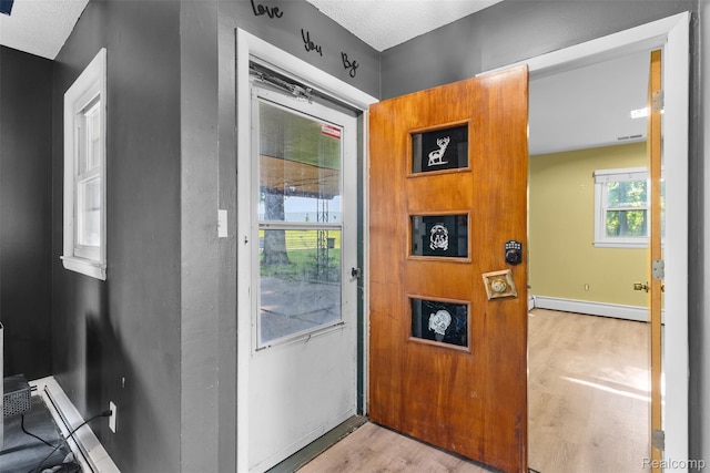 1408 Stephens Ave, Flint, MI 48507 - entryway with baseboard heating and wood finished floors