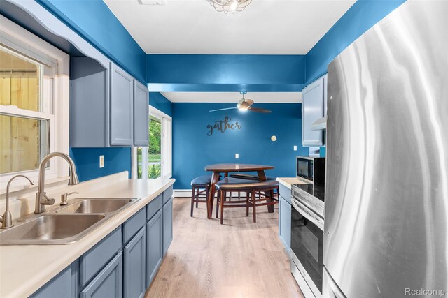1408 Stephens Ave, Flint, MI 48507 - kitchen with stainless steel appliances, light wood-style flooring, light countertops, and ceiling fan