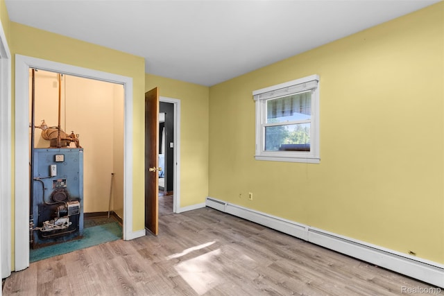 1408 Stephens Ave, Flint, MI 48507 - unfurnished bedroom with a baseboard radiator and wood finished floors