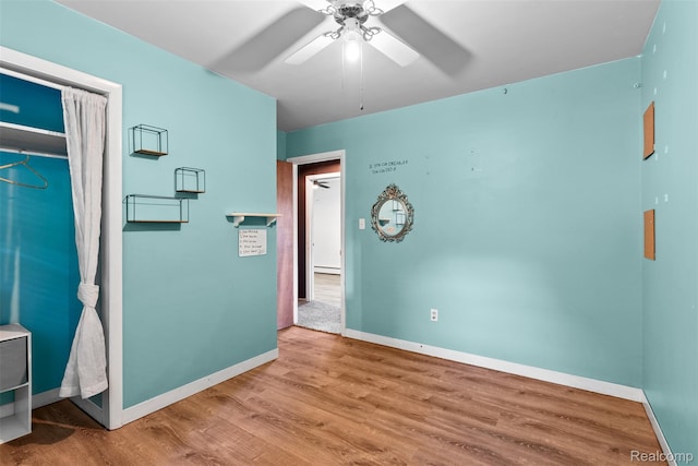 1408 Stephens Ave, Flint, MI 48507 - unfurnished bedroom featuring wood finished floors, a baseboard heating unit, and a ceiling fan