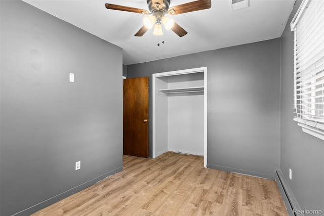 1408 Stephens Ave, Flint, MI 48507 - unfurnished bedroom with a baseboard radiator, a closet, wood finished floors, ceiling fan, and baseboards