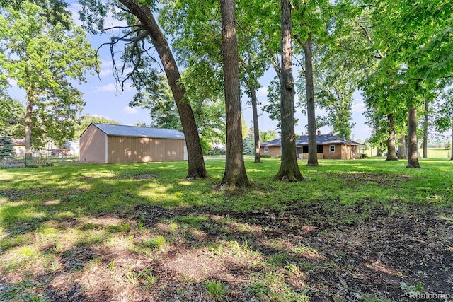 1408 Stephens Ave, Flint, MI 48507 - view of grassy yard with an outbuilding and an outdoor structure