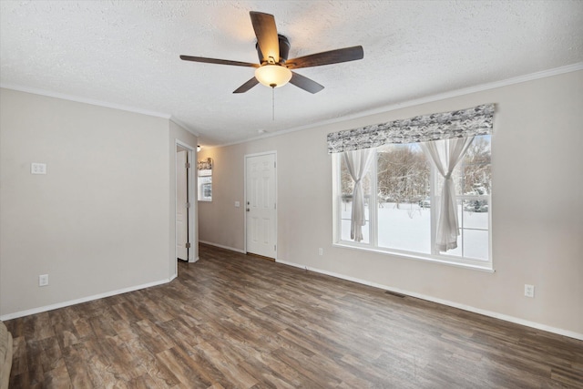 spare room with ceiling fan, ornamental molding, dark hardwood / wood-style floors, and a textured ceiling