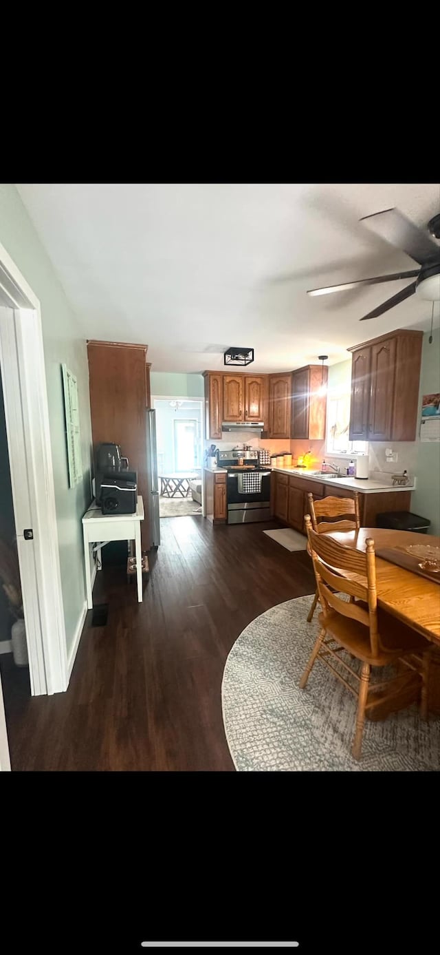 dining area featuring ceiling fan and dark hardwood / wood-style floors