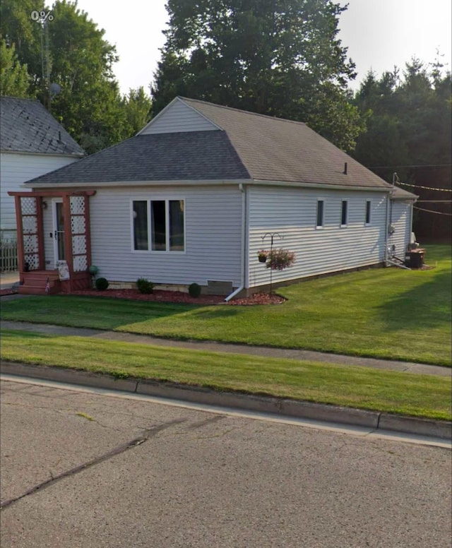 view of side of home featuring a lawn