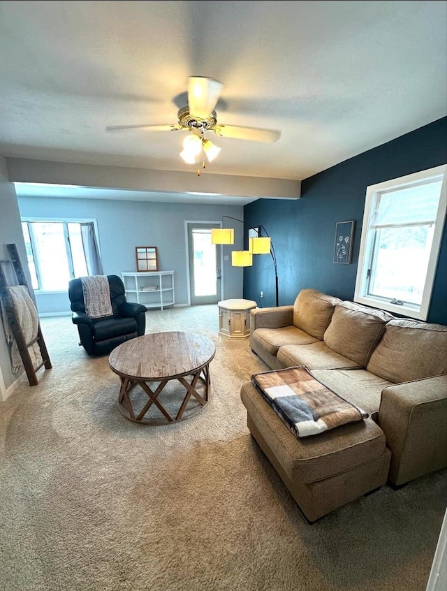 carpeted living room featuring ceiling fan and plenty of natural light