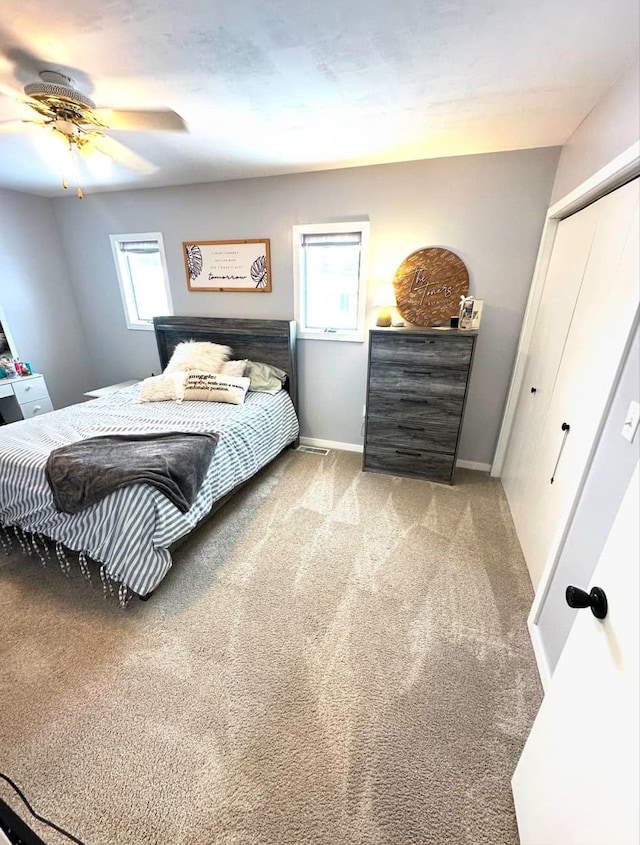 carpeted bedroom with ceiling fan