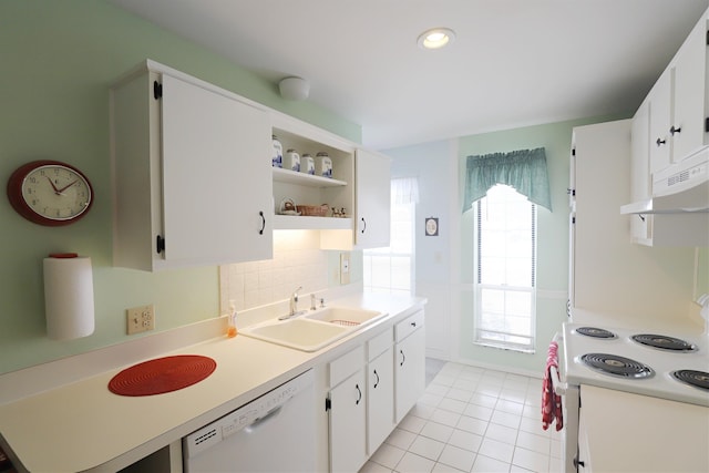 kitchen with light tile patterned flooring, sink, white cabinetry, tasteful backsplash, and white appliances