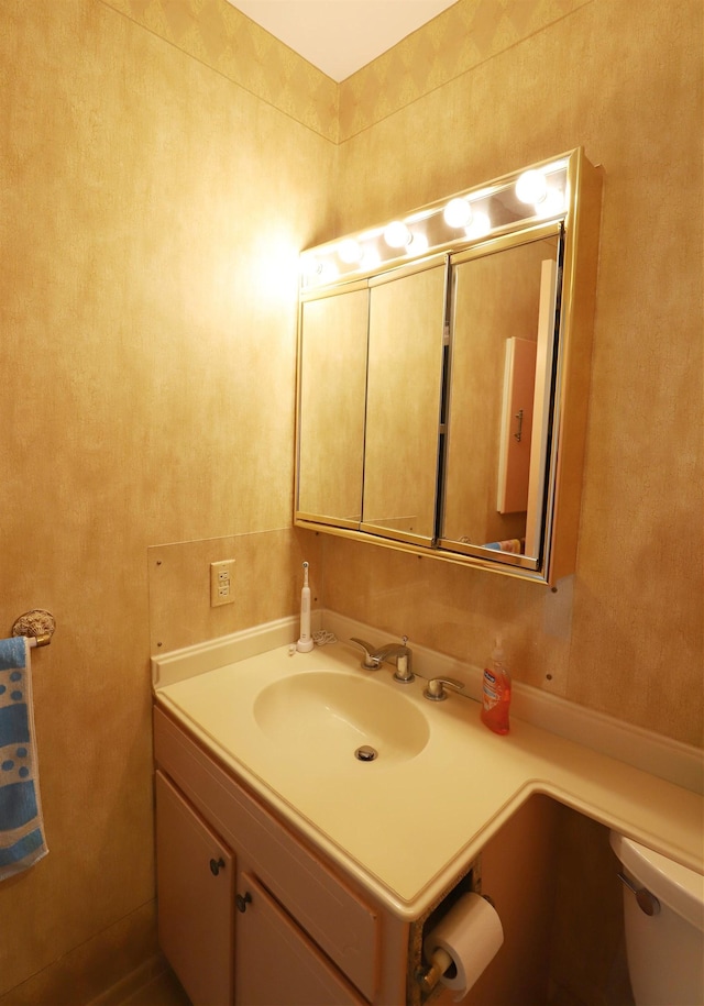 bathroom featuring vanity and toilet