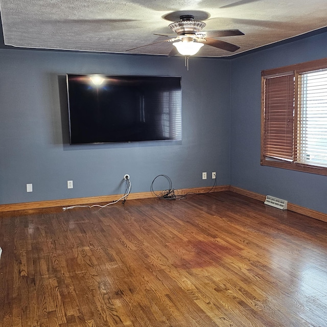 unfurnished room with hardwood / wood-style flooring, a textured ceiling, and ceiling fan