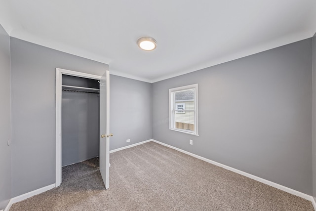 unfurnished bedroom featuring a closet and carpet