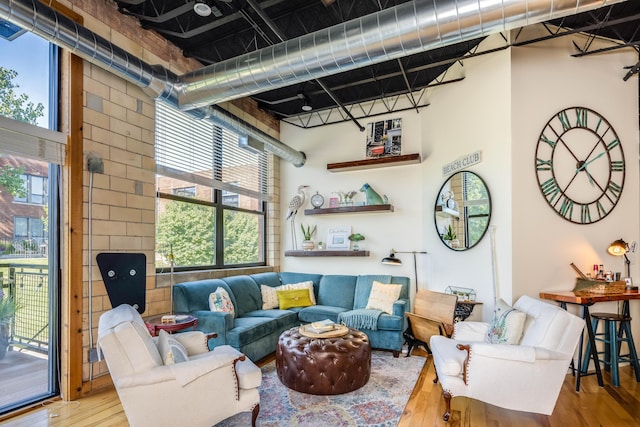 interior space featuring a high ceiling, hardwood / wood-style flooring, and a wealth of natural light