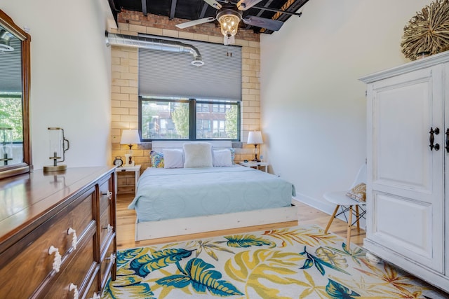 bedroom with multiple windows and light wood-type flooring