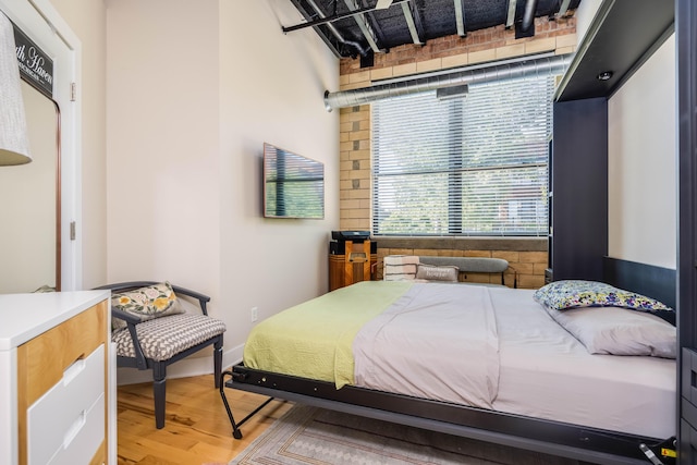 bedroom with hardwood / wood-style floors