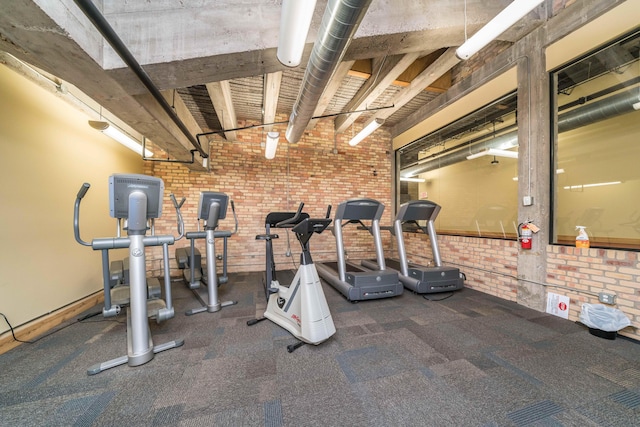 gym featuring brick wall