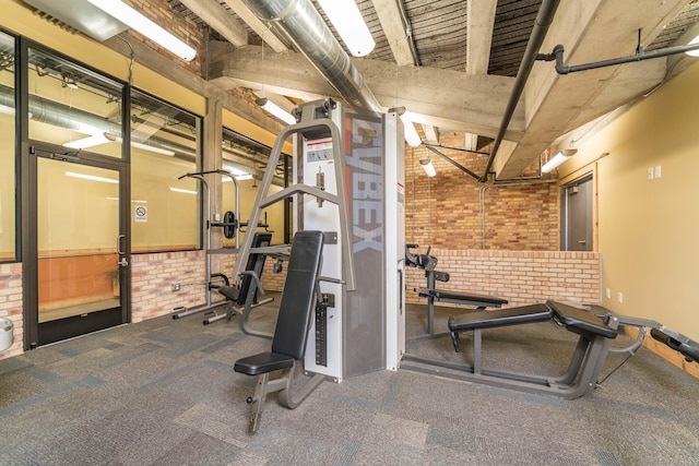 exercise room with brick wall