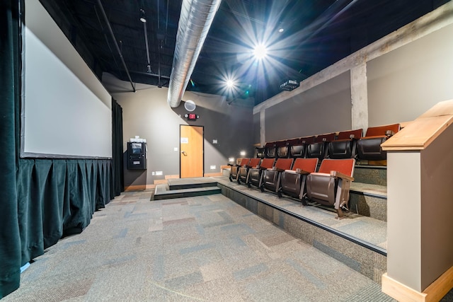 cinema with carpet flooring and a high ceiling