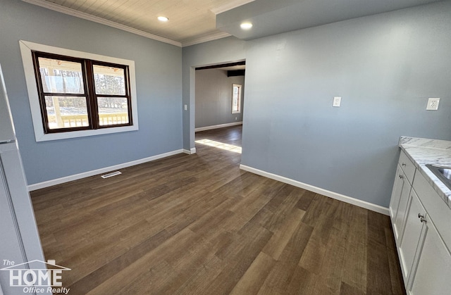 unfurnished dining area featuring ornamental molding and dark wood-type flooring