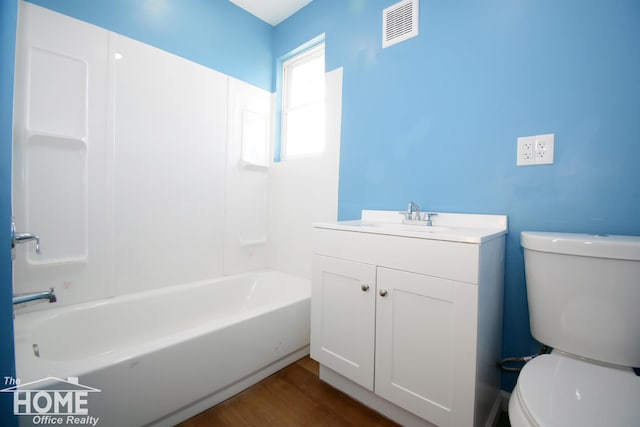 full bathroom featuring vanity, tub / shower combination, wood-type flooring, and toilet