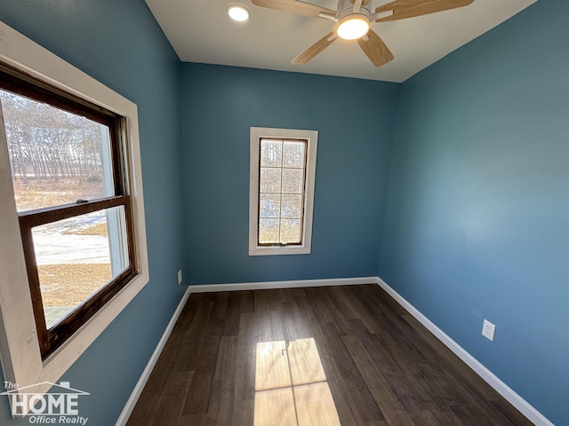 empty room with ceiling fan and dark hardwood / wood-style floors